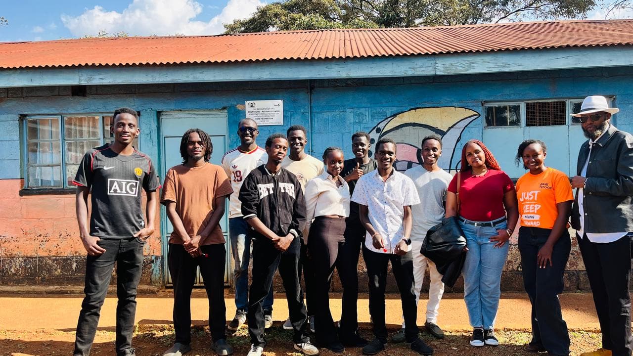 Young people standing together at a community gathering, smiling and connected.